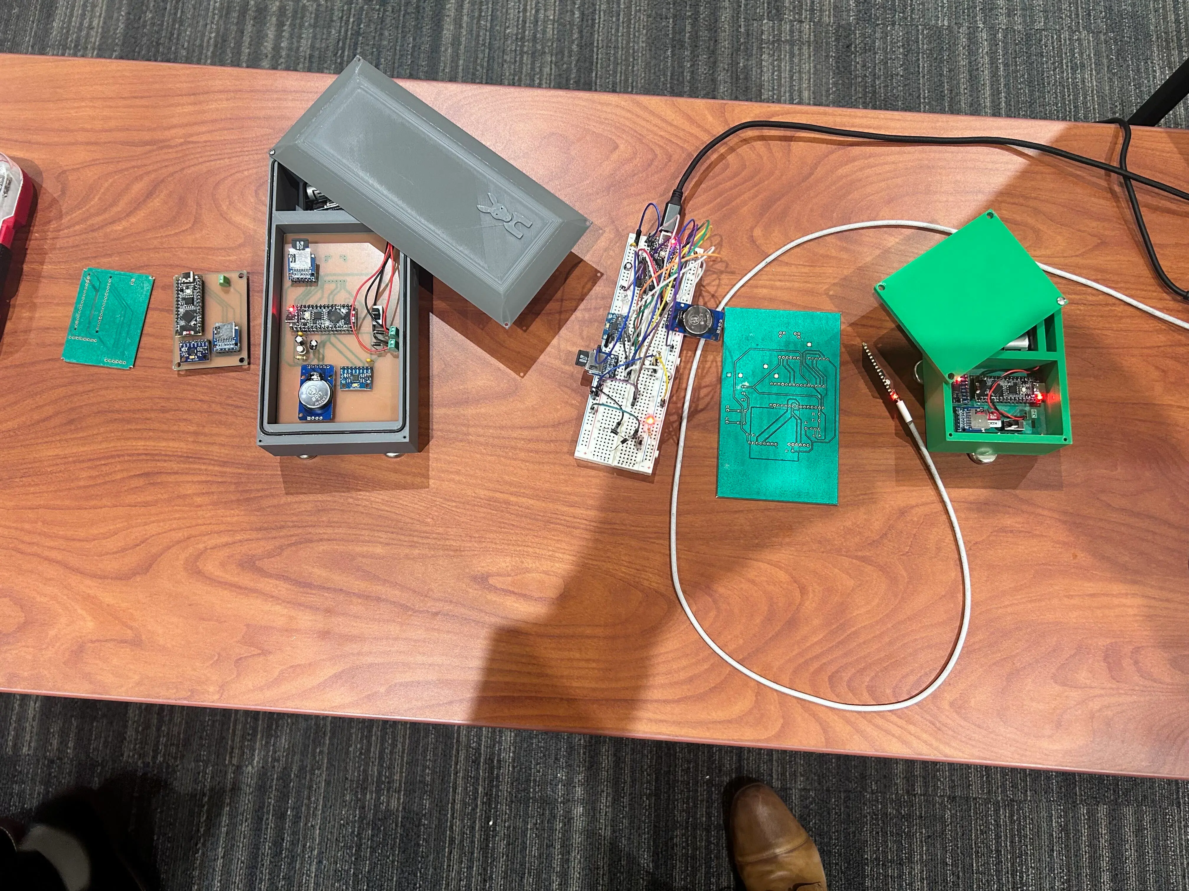 The Outlier Node sensor in its printed enclosure, next to the bare board